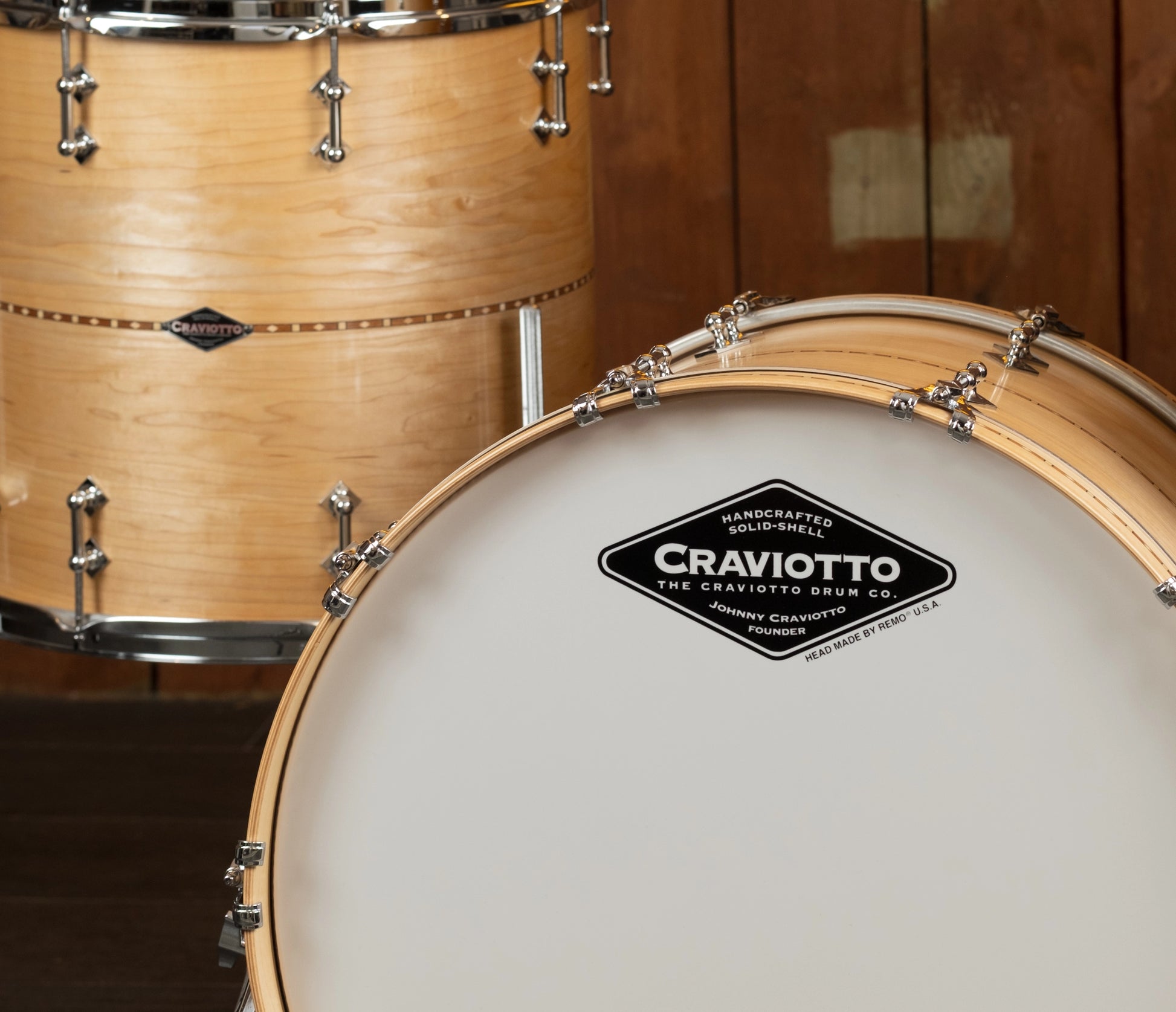Close-up of a Craviotto drum with a wooden finish and visible brand logo.