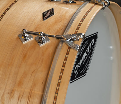 Close-up of a Craviotto drum with maple finish and visible brand logo.