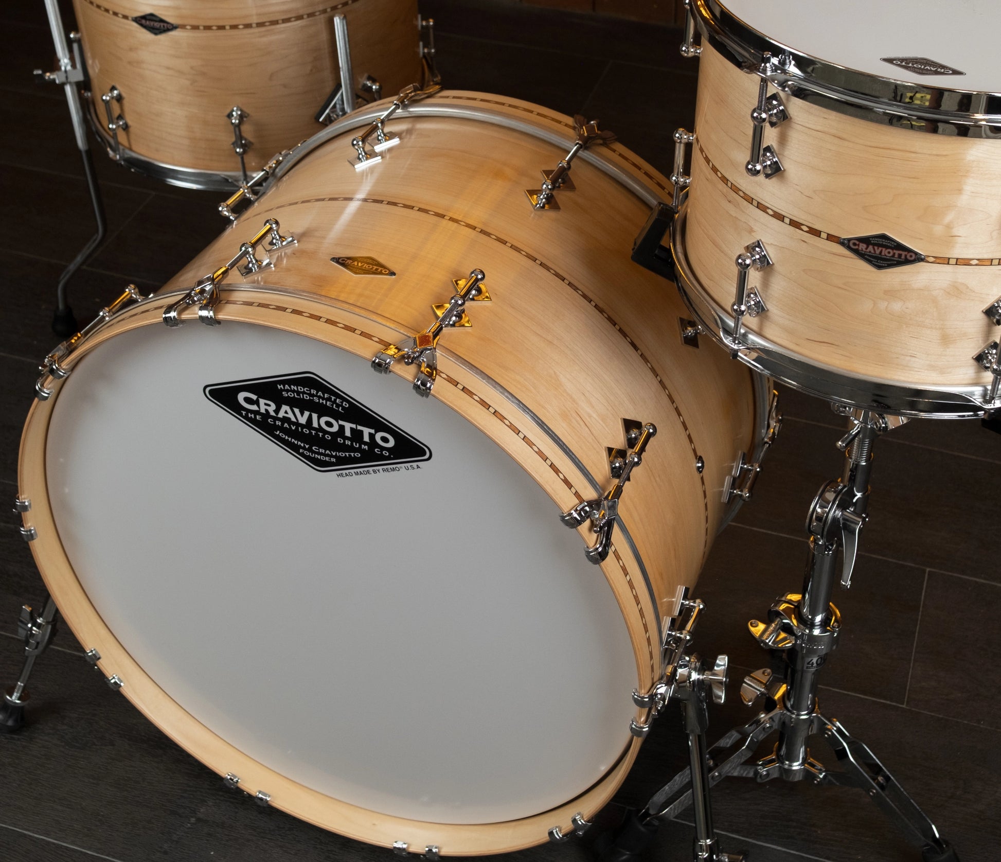 Drum set with Craviotto logo on a dark tiled floor