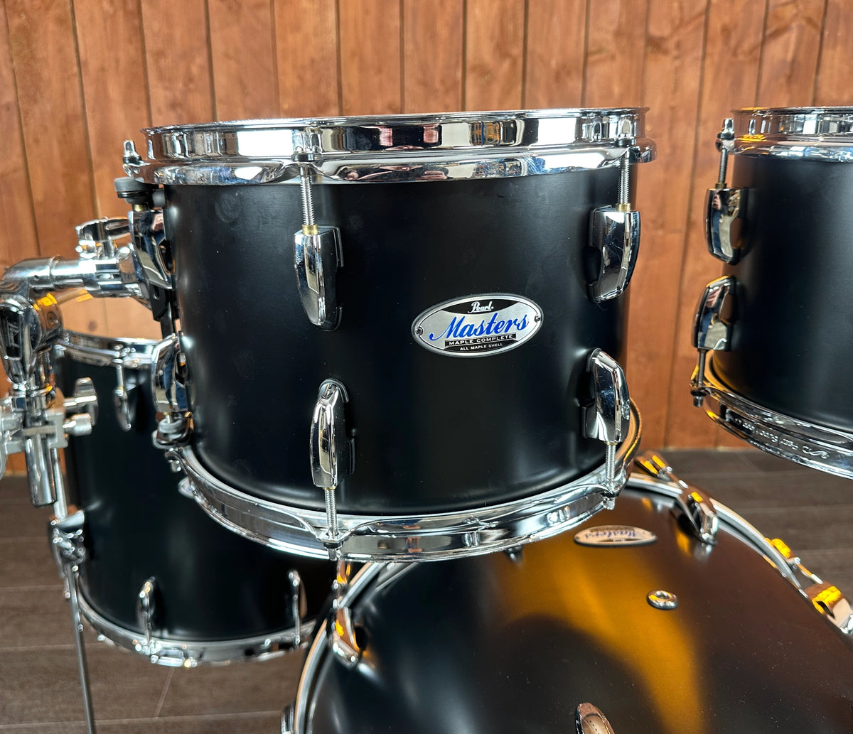 Close-up of Pearl Masters rack tom shell, badge and chrome hoops