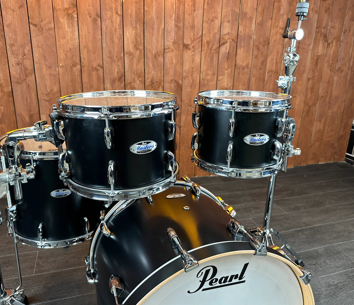 Angled close-up of two Pearl Masters rack toms in Matt Caviar Black