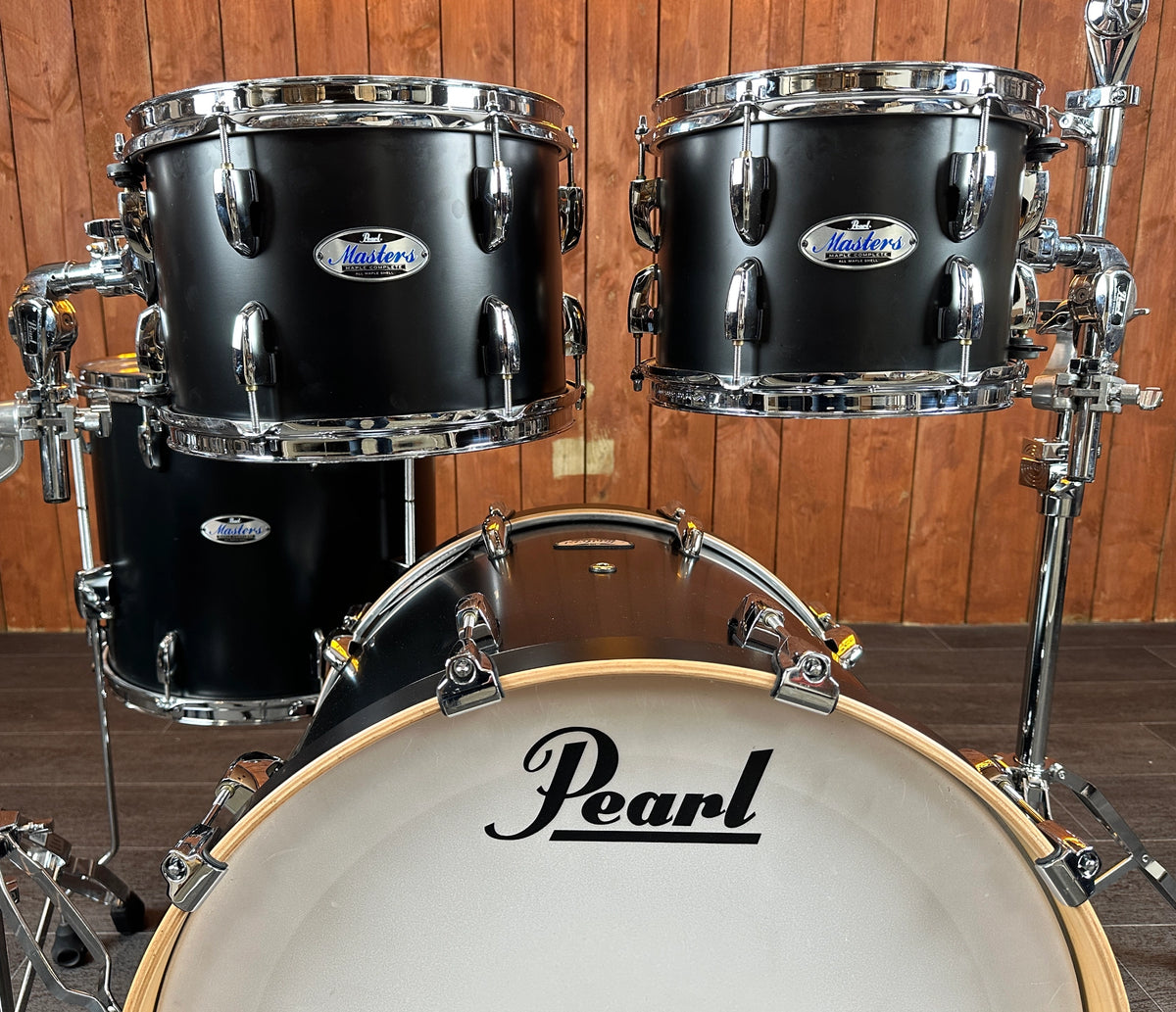 Close-up of Pearl Masters rack toms and bass drum in Matt Caviar Black
