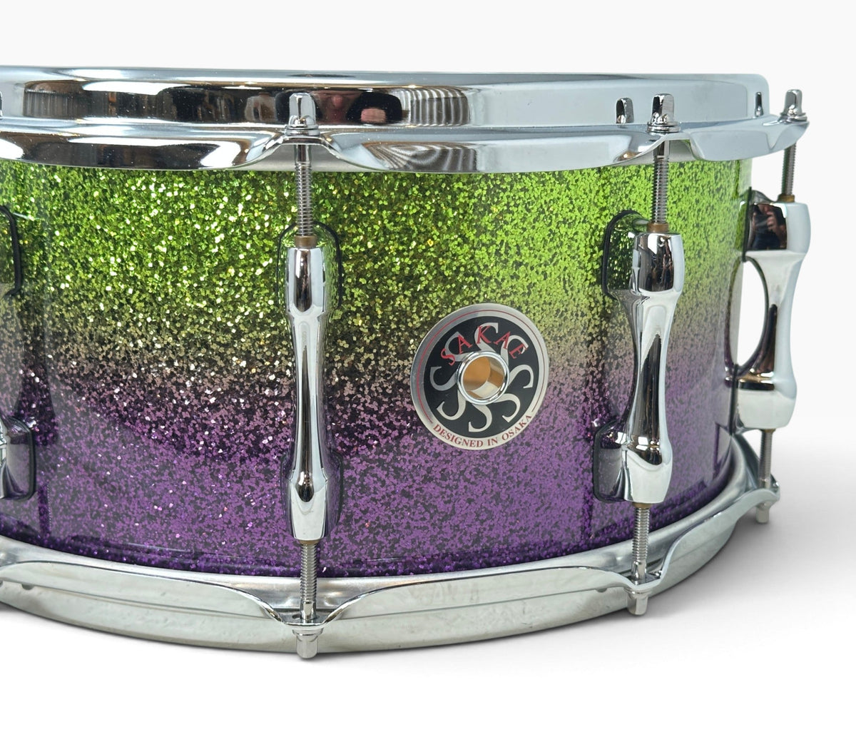 Sakae Evolved 14" x 6.5" Snare Drum in Grapes Green to Purple Sparkle – close-up of badge and colour fade