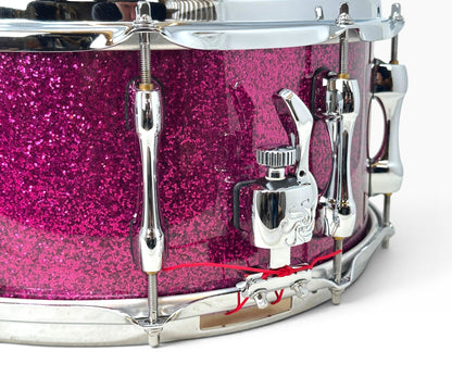 Sakae Evolved 14" x 6.5" Snare Drum in Magenta Sparkle – close-up of snare strainer
