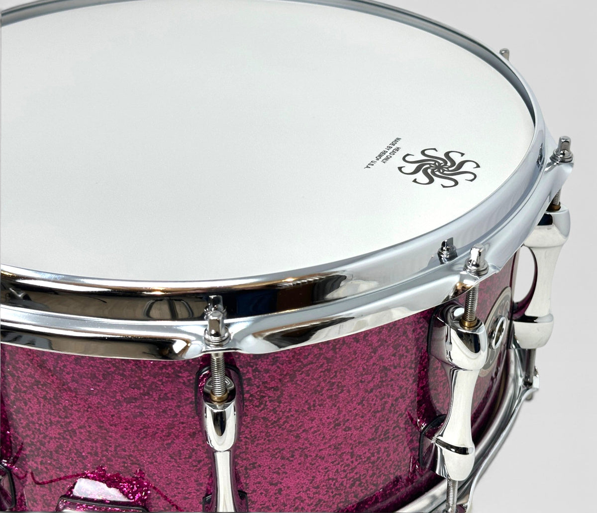 Sakae Evolved 14" x 6.5" Snare Drum in Magenta Sparkle – close-up of batter head and shell