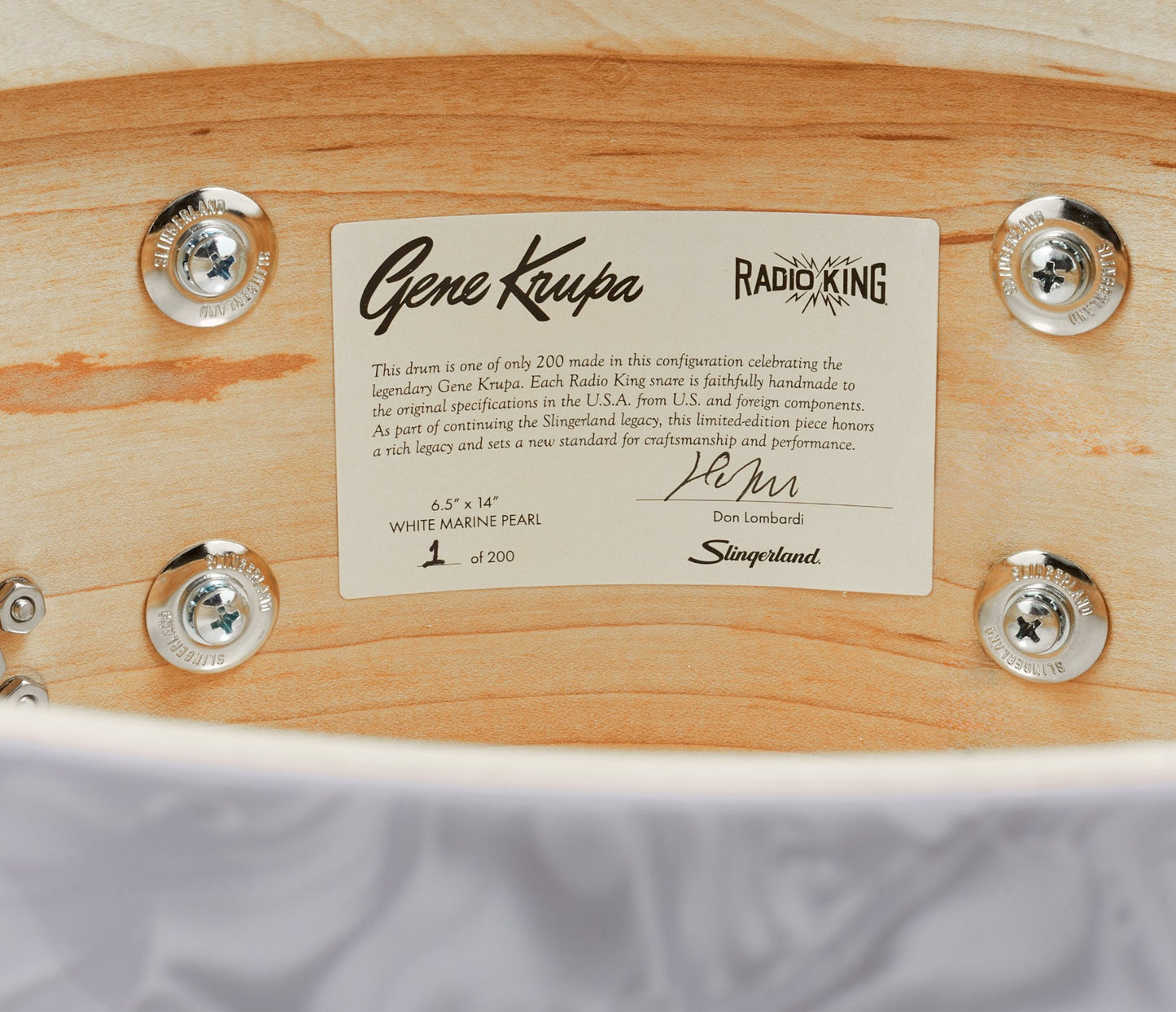 Close-up of a snare drum with a Gene Krupa Radio King label on a wooden surface.