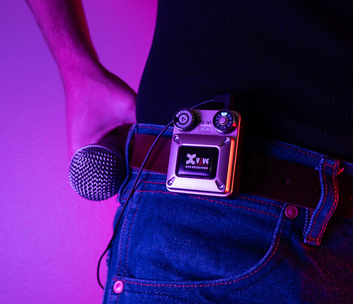 XVIVE U45 belt-pack receiver clipped to a performer's waistband