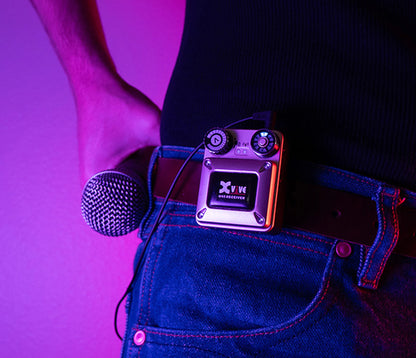 XVIVE U45 belt-pack receiver clipped to a performer's waistband