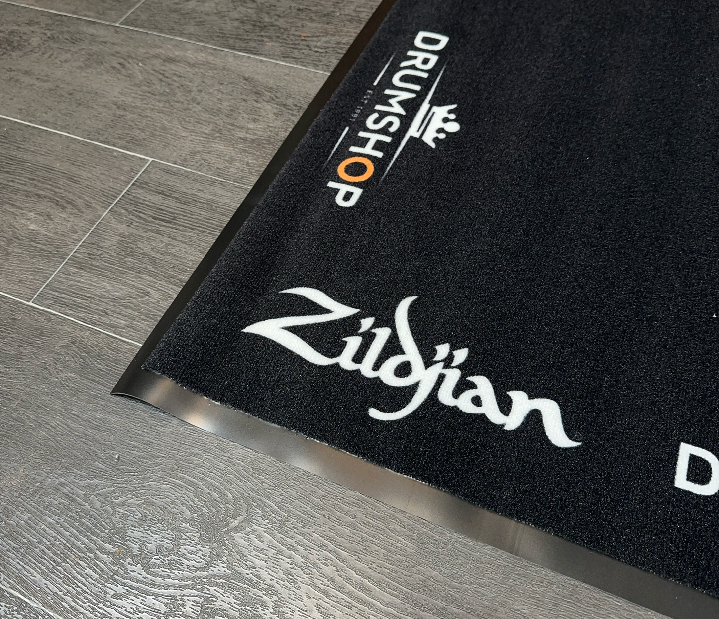 Drumshop x Zildjian Deluxe Rubber Backed Drum Mat logos closeup